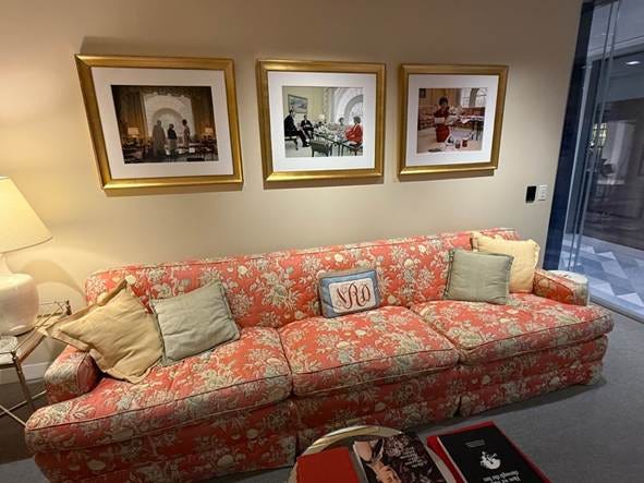 A couch with pillows and a table with pictures on the wall

AI-generated content may be incorrect.