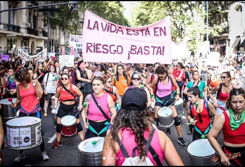 A group of people marching in a street with drums
AI-generated content may be incorrect. A group of people marching in a street with drums
AI-generated content may be incorrect.