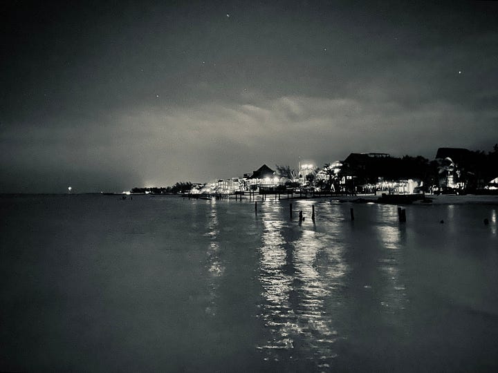 photos of sunsets and beach scenes after dark in Holbox, Mexico. The nighttime beach scenes appear to have been taken during the daytime, but because of the phone camera's ability to regulate light, the photos look like they were taken during the day. 