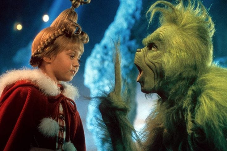 This may contain: a man standing next to a green creature This may contain: a man standing next to a green creature