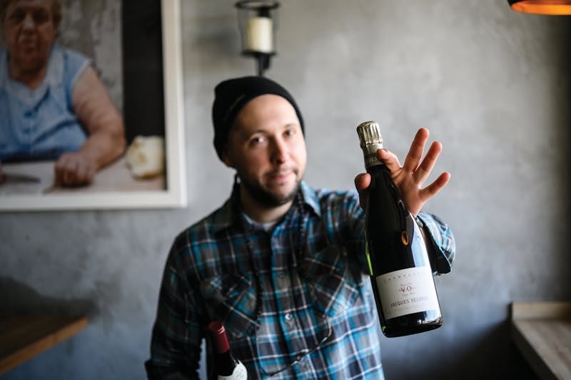a man holding a bottle of wine