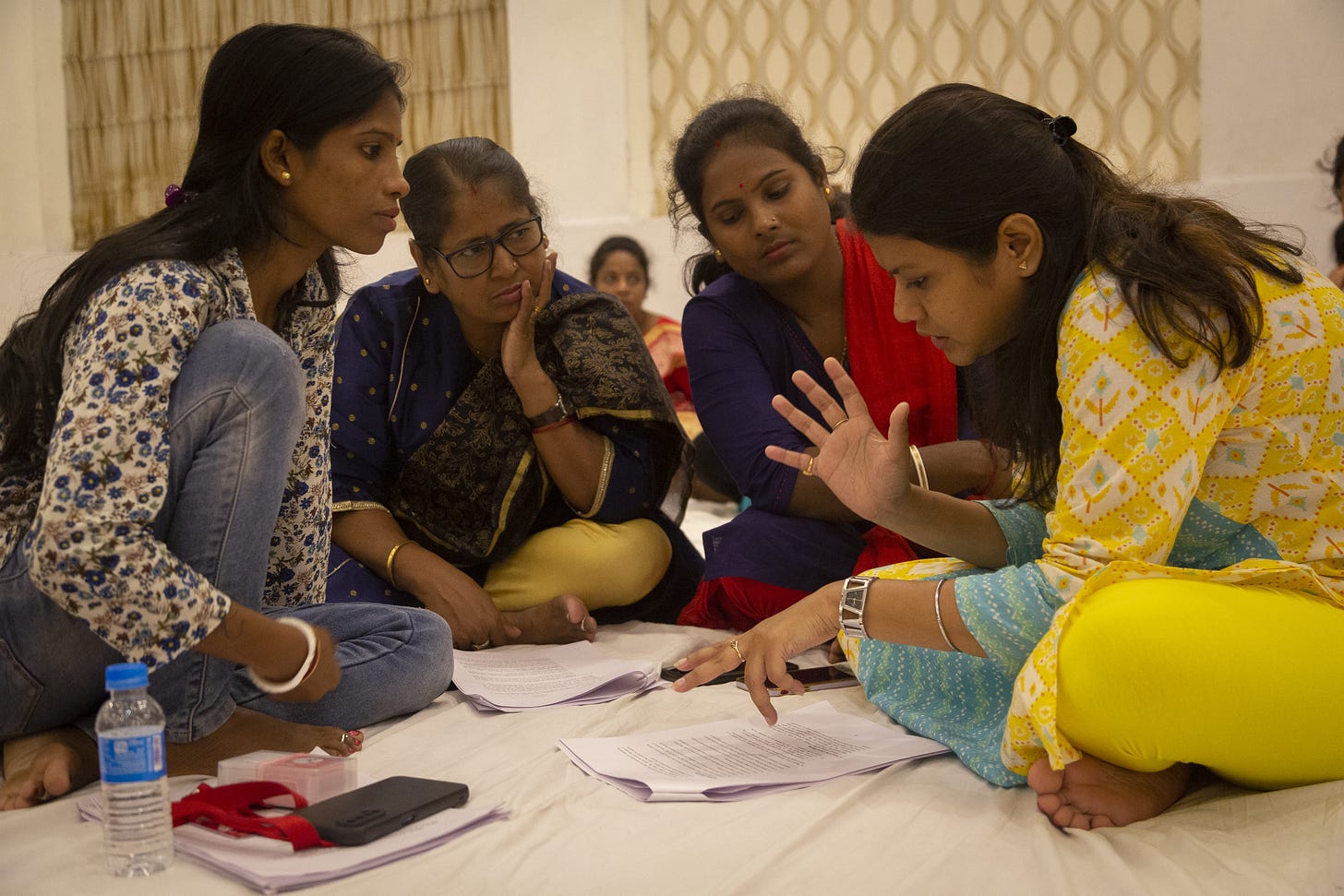 Group of four women sitting in a circle, having a discussion