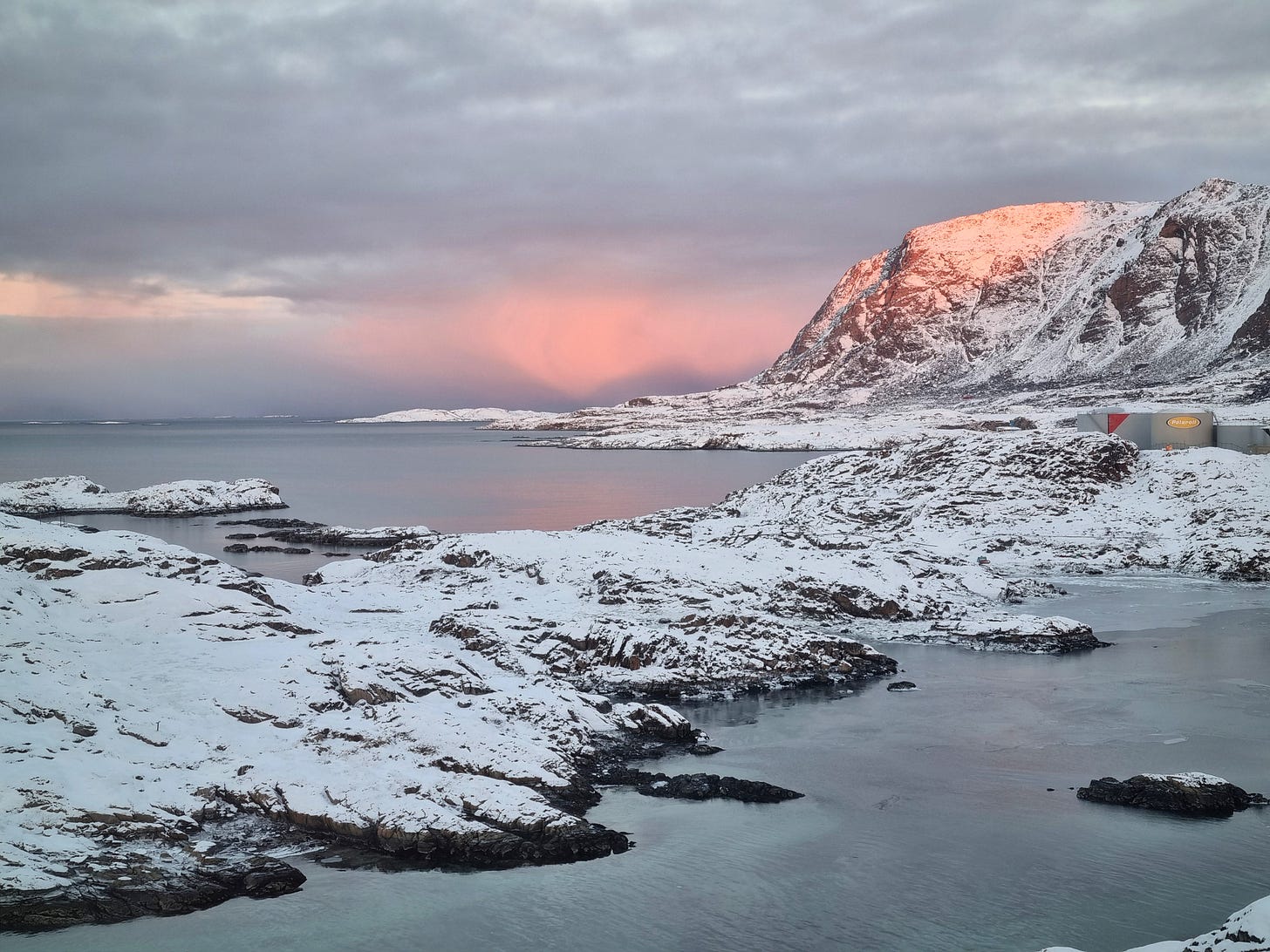 Pink sunrise on clouds beyond Palasip Qaqqaa in Sisimiut, Greenland.