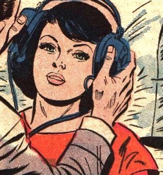 This may contain: a woman wearing headphones and listening to music