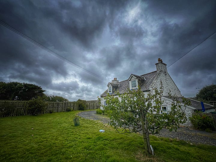 Two photographs of my cottage, altered using a photo app to make the sky and colours more dramatic to capture my mood.