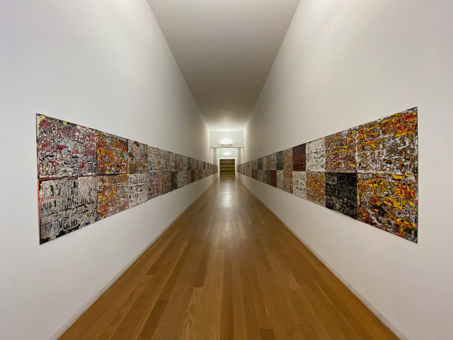 A corridor lines with the work of Mark Bradford at the Museu de Arte Contemporânea de Serralves in Porto, Portugal
