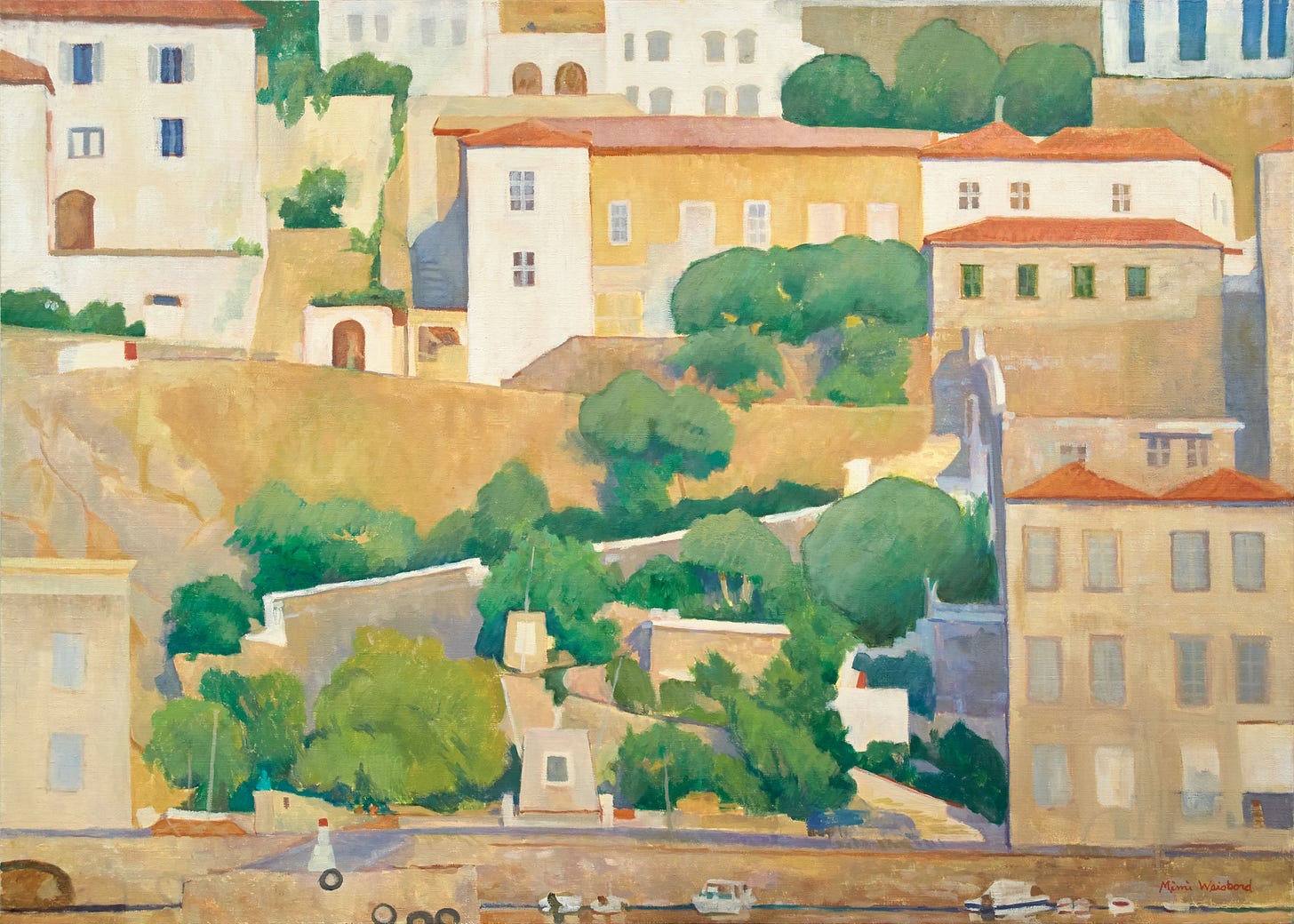 Tightly clustered houses with terracotta roofs on a hillside descending with switchback walls to a waterfront with small boats.