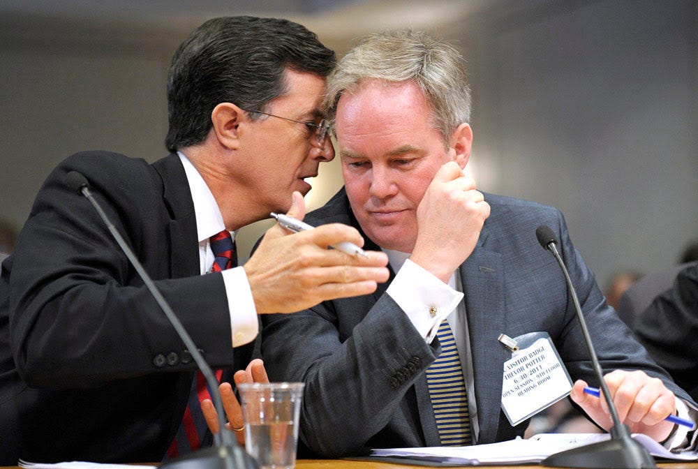 Steven Colbert sits with Trevor Potter testifying before the Federal Election Commission.