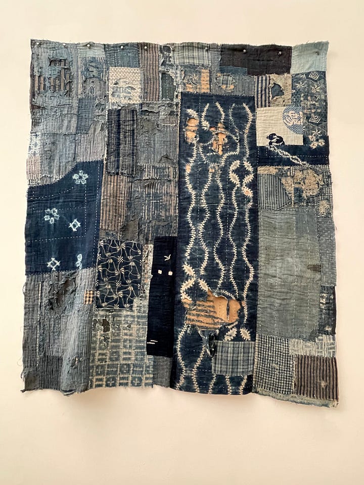 A quilt and a detail of the same quilt comprised of indigo blue dyed cotton fabric scraps.