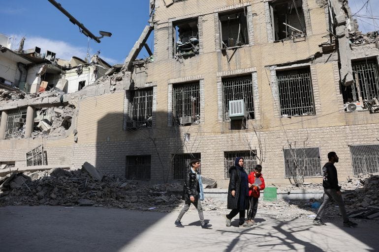 People walk past damaged buildings following a strike on a police station, amid the U.S.-Israeli conflict with Iran, in Tehran, Iran, March 4, 2026. Majid Asgaripour/WANA (West Asia News Agency) via REUTERS ATTENTION EDITORS - THIS PICTURE WAS PROVIDED BY A THIRD PARTY People walk past damaged buildings following a strike on a police station, amid the U.S.-Israeli conflict with Iran, in Tehran, Iran, March 4, 2026. Majid Asgaripour/WANA (West Asia News Agency) via REUTERS ATTENTION EDITORS - THIS PICTURE WAS PROVIDED BY A THIRD PARTY