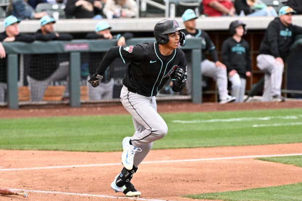 Druw Jones of the Arizona Diamondbacks runs out a fly ball during the second inning of a spring training Spring Breakout game against the Colorado...