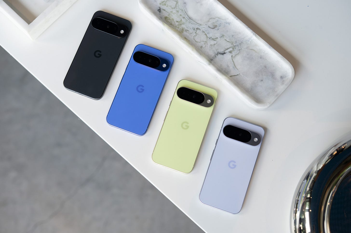 Google Pixel 10 shown in four color options.