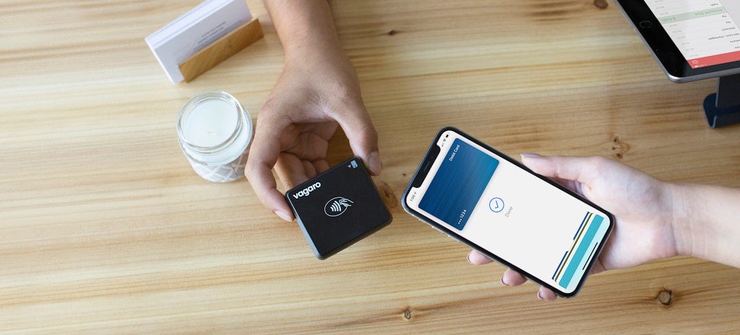 A business owner is checking out a customer using Apple Pay with the Vagaro contactless card payment system. The sleek and modern payment process introduces a touch of convenience, enhancing the overall checkout experience. A business owner is checking out a customer using Apple Pay with the Vagaro contactless card payment system. The sleek and modern payment process introduces a touch of convenience, enhancing the overall checkout experience.