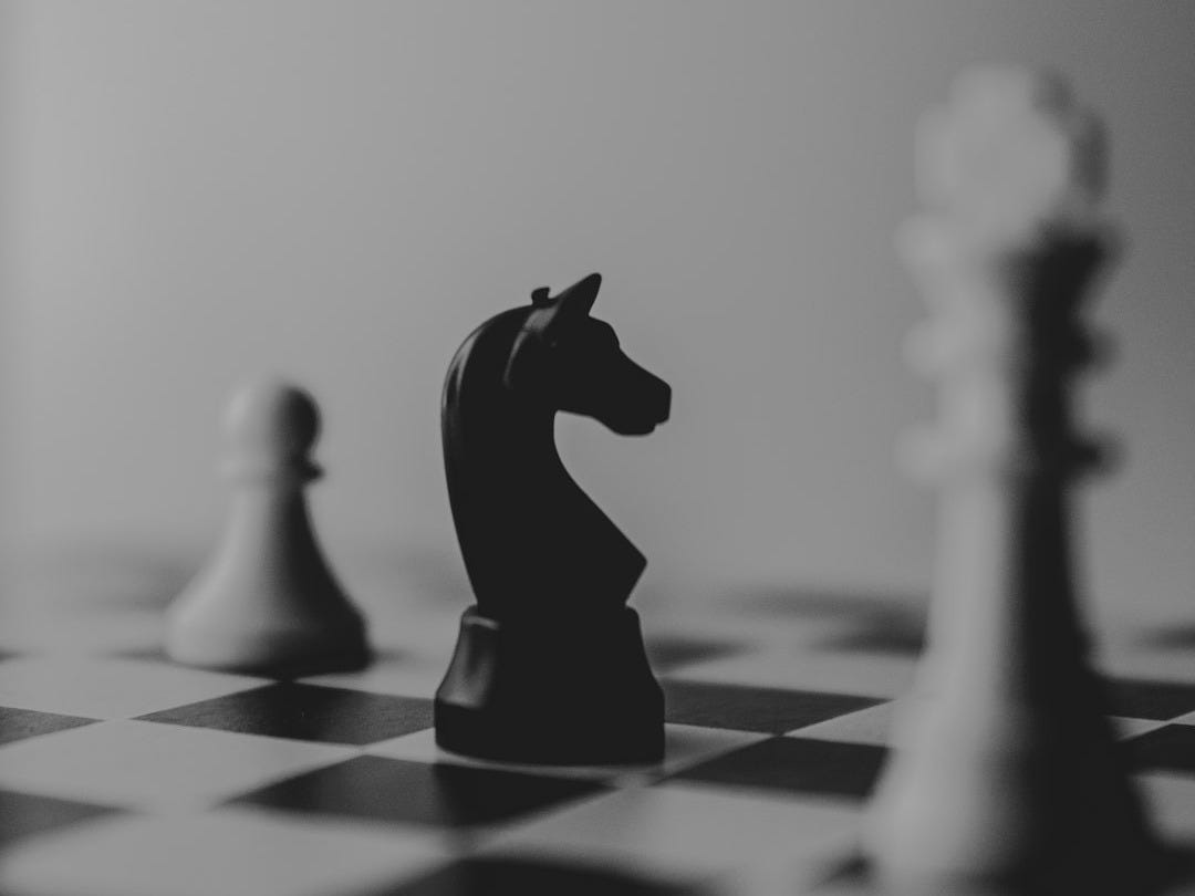black horse chess piece near roque chess piece black horse chess piece near roque chess piece