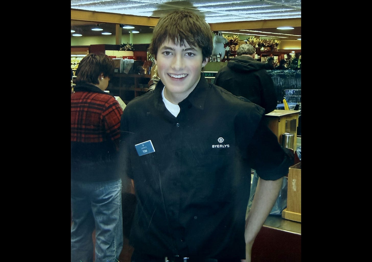 Tom Wahlin in a grocery bagging uniform at 15 years old