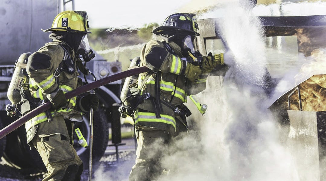 three fireman preventing fire during daytime three fireman preventing fire during daytime