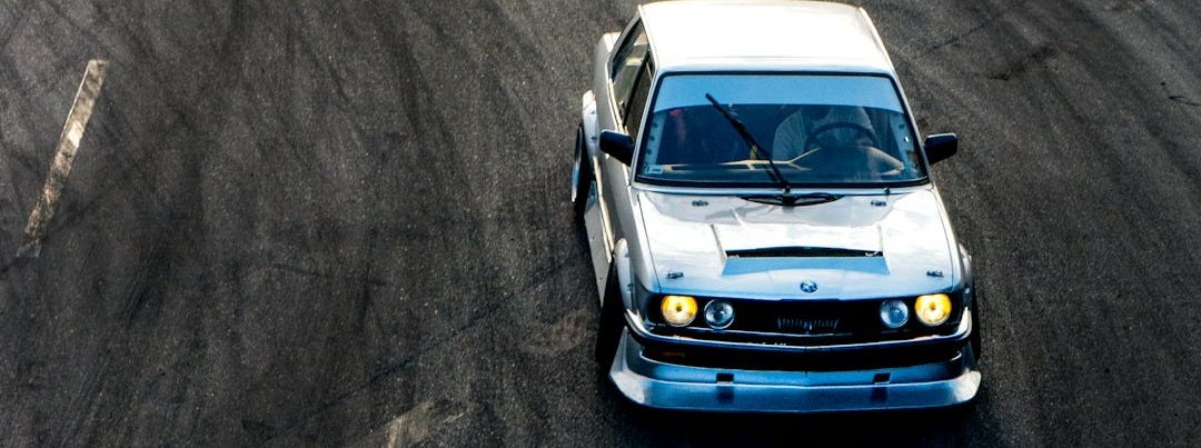 white car on gray asphalt road