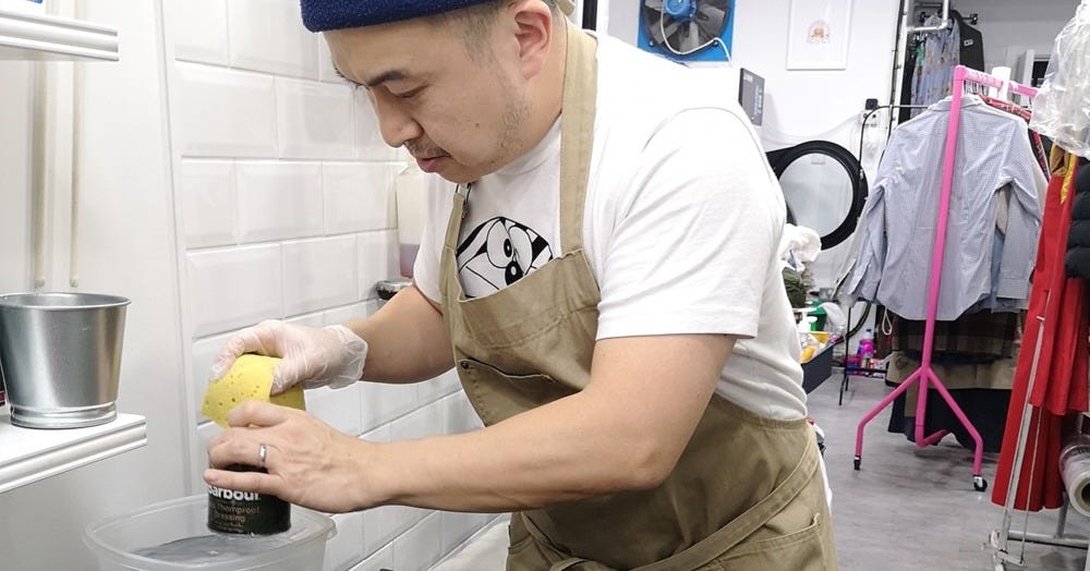 Tony, owner of The Steam Room, hand-cleans a coat Tony, owner of The Steam Room, hand-cleans a coat