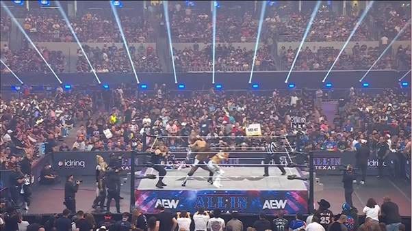 A crowd of people in a wrestling ring

AI-generated content may be incorrect.