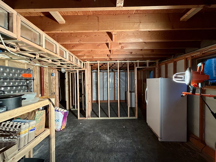 Photo mosaic of stud walls and bulkheads being built and placed.