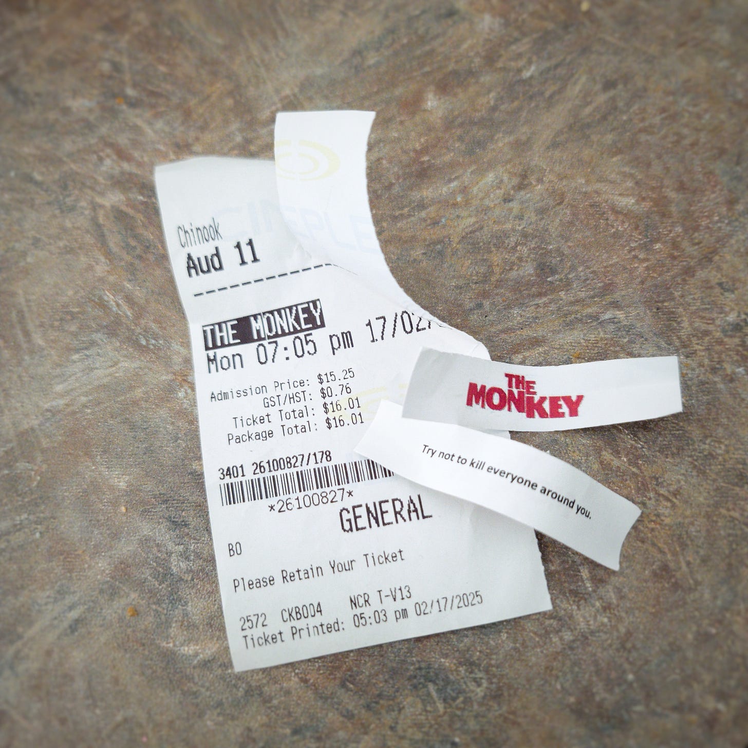 A photo of a ticket to The Monkey and two fortunes from cookies. One says, "Try not to kill everyone around you," while the other has the logo for the movie, The Monkey.