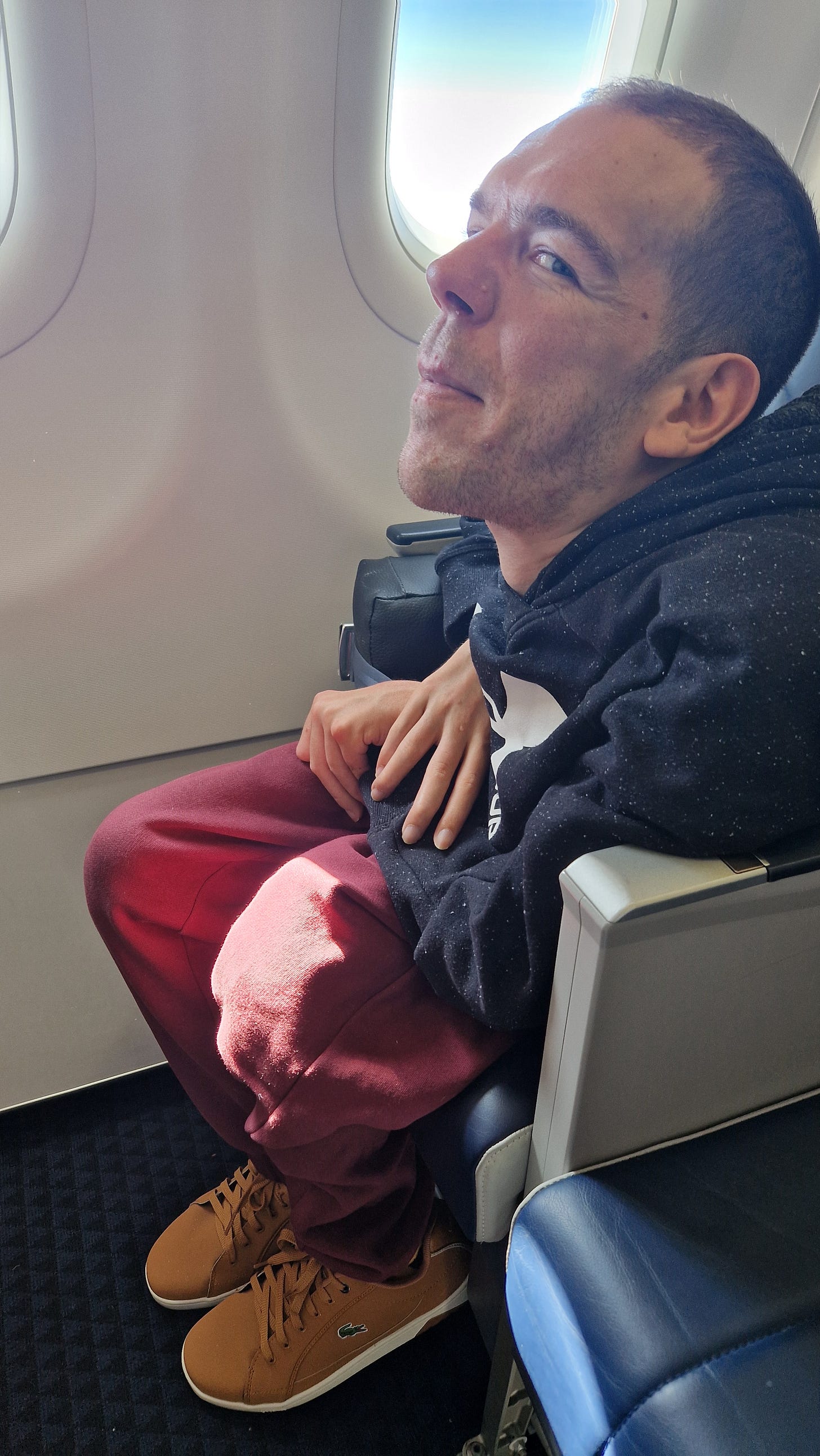 Me sitting next to the window in the plane 