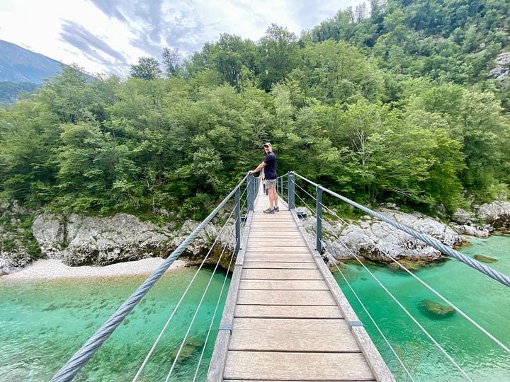 Wildflowers and vivid blue water in Slovenia's Soča river valley