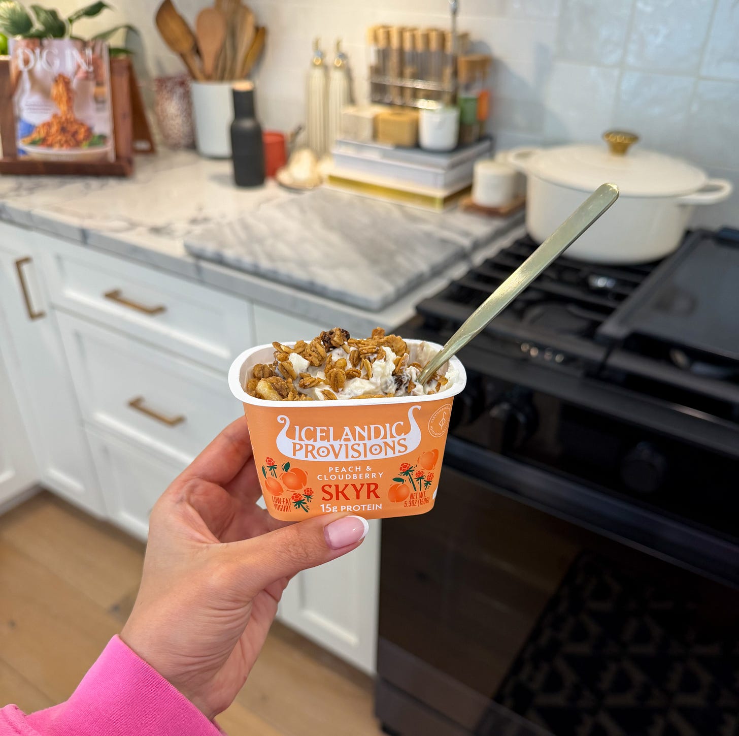 Erin holding Icelandic Provisions Peach & Cloudberry Skyr.