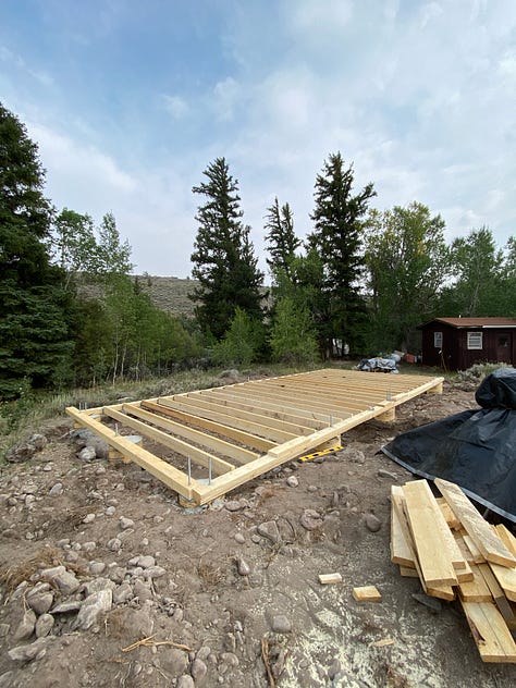 log cabin in various stages of completion.