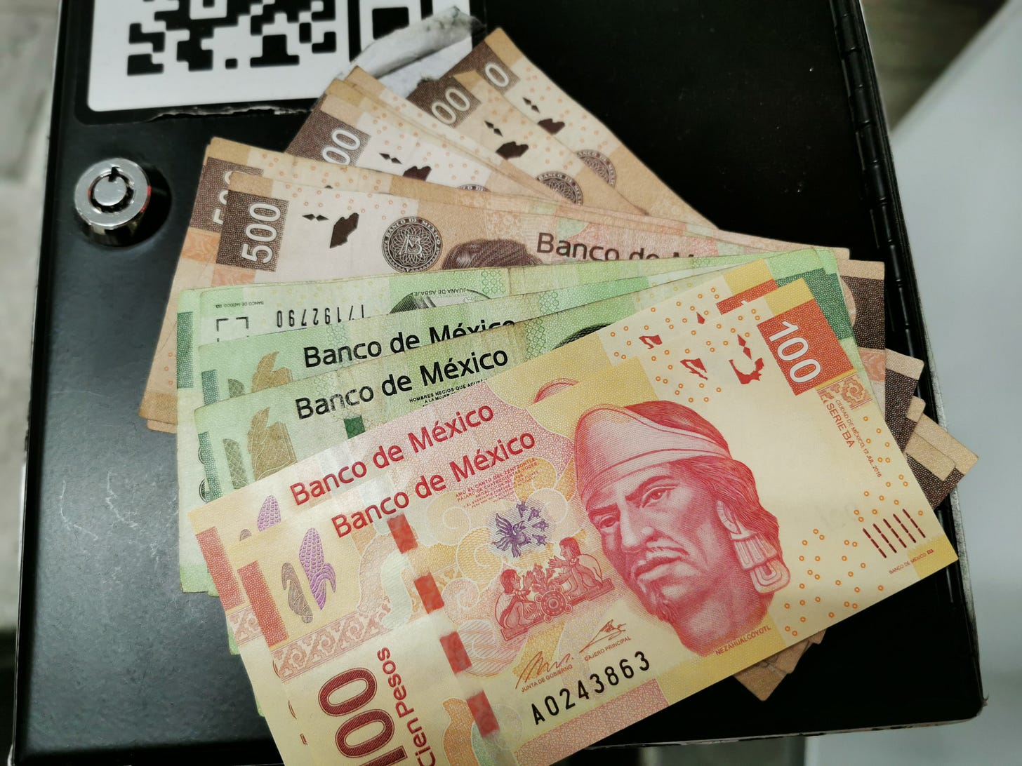 Mexican pesos fanned out on a table