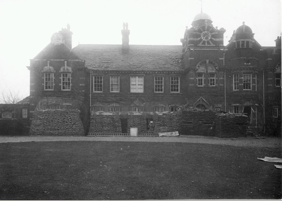 A two storey Victorian-era block which is sandbagged half way up. Windows are smashed and there is some damage to the roof, but overall wooden framings are intact and it has suffered less damage overall. A two storey Victorian-era block which is sandbagged half way up. Windows are smashed and there is some damage to the roof, but overall wooden framings are intact and it has suffered less damage overall.