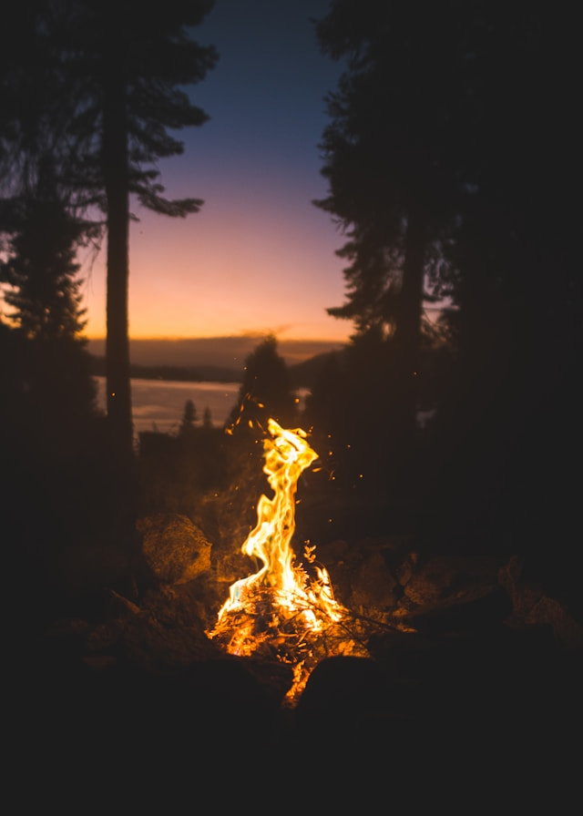 photograph of a campfire at sunset
