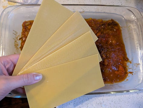 Assembling bottom layers of lasagna.