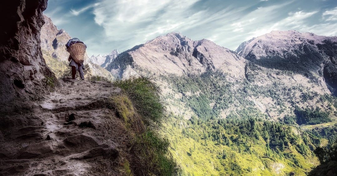 green and gray mountain under cloudy sky during daytime