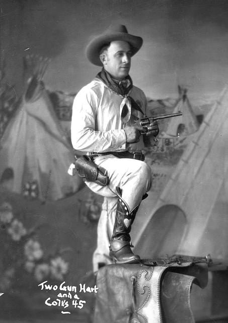 Two Gun Hart posing with revolver