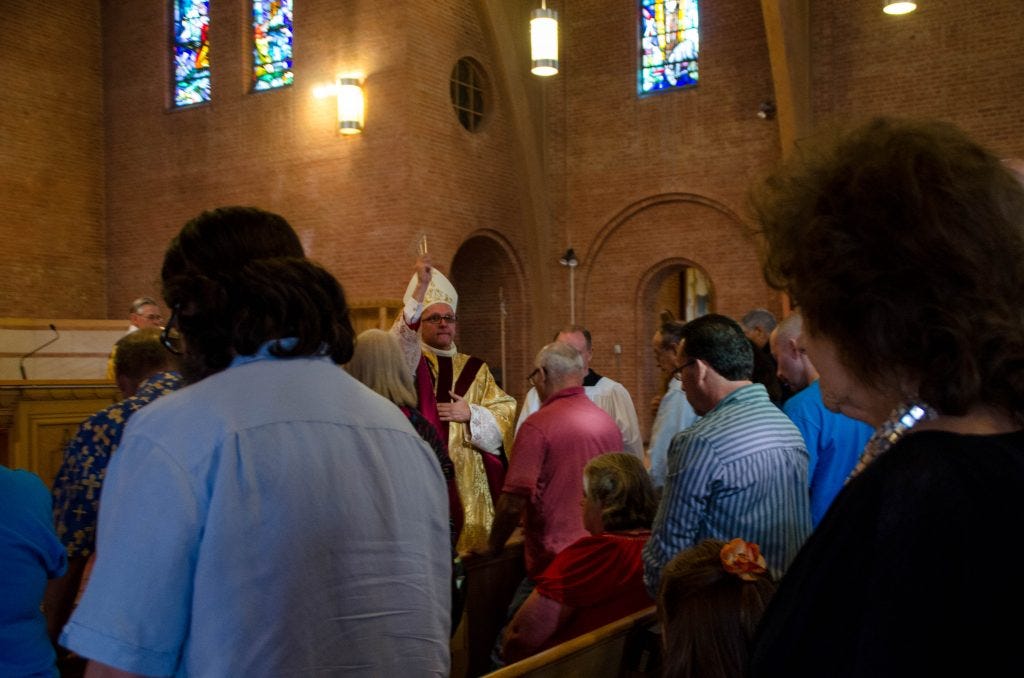 Bishop Wall blesses the Spanish Market artists at Mass.