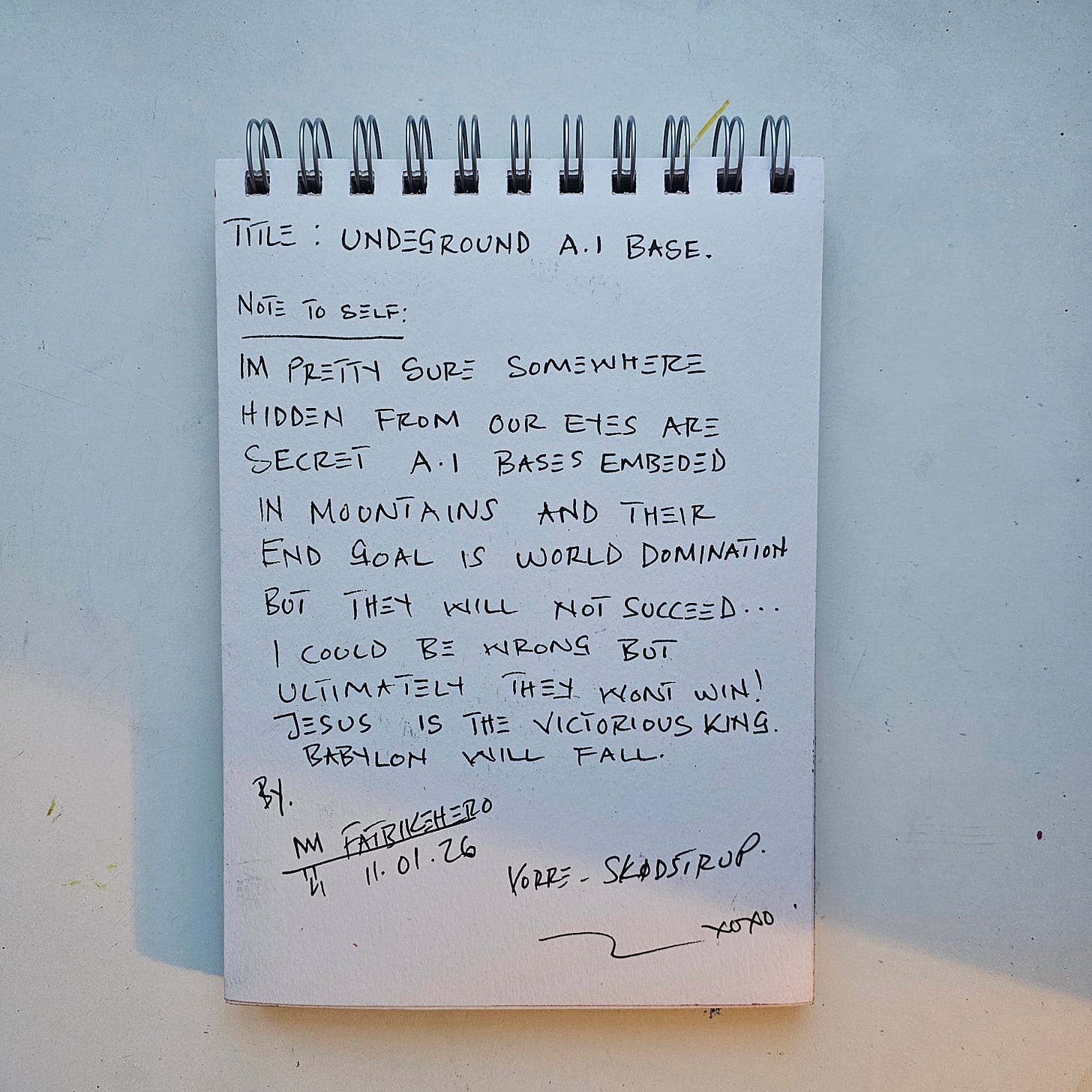 A handwritten note by FatbikeHero dated 11.01.26. The text reads 'Title: Underground A.I. Base' and discusses secret AI bases in mountains, world domination, and a spiritual conclusion stating 'Jesus is the victorious king. Babylon will fall.' Signed in Vorre-Skødstrup. A handwritten note by FatbikeHero dated 11.01.26. The text reads 'Title: Underground A.I. Base' and discusses secret AI bases in mountains, world domination, and a spiritual conclusion stating 'Jesus is the victorious king. Babylon will fall.' Signed in Vorre-Skødstrup.