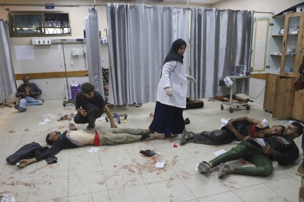 Palestinians who were injured during a food distribution at a center run by the Gaza Humanitarian Foundation, a U.S.-backed organization approved by Israel, receive treatment on the floor of Nasser Hospital in Khan Younis, southern Gaza Strip, Saturday, July 19, 2025. (AP Photo/Mariam Dagga, File)