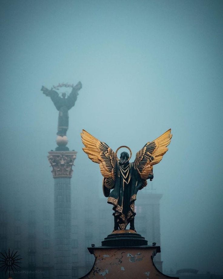 This may contain: an angel statue on top of a building in the fog This may contain: an angel statue on top of a building in the fog
