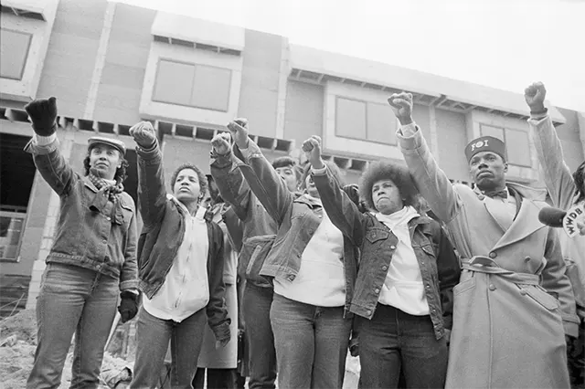 A poignant moment: Mourners pay their respects outside the remnants of the MOVE headquarters during John Africa's funeral procession. A poignant moment: Mourners pay their respects outside the remnants of the MOVE headquarters during John Africa's funeral procession.