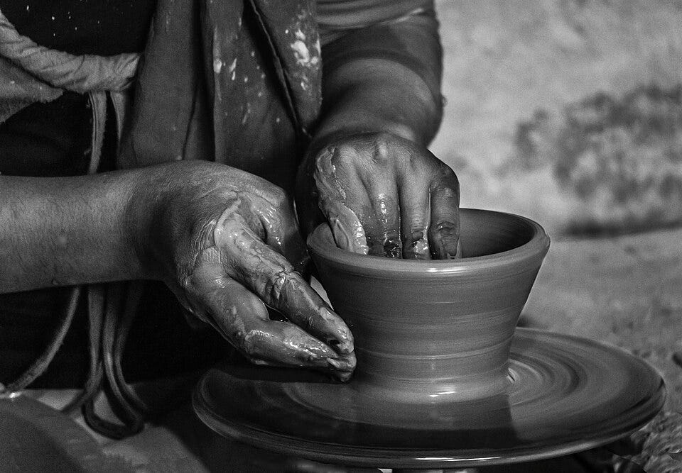 File:Pottery Hands in mud.jpg