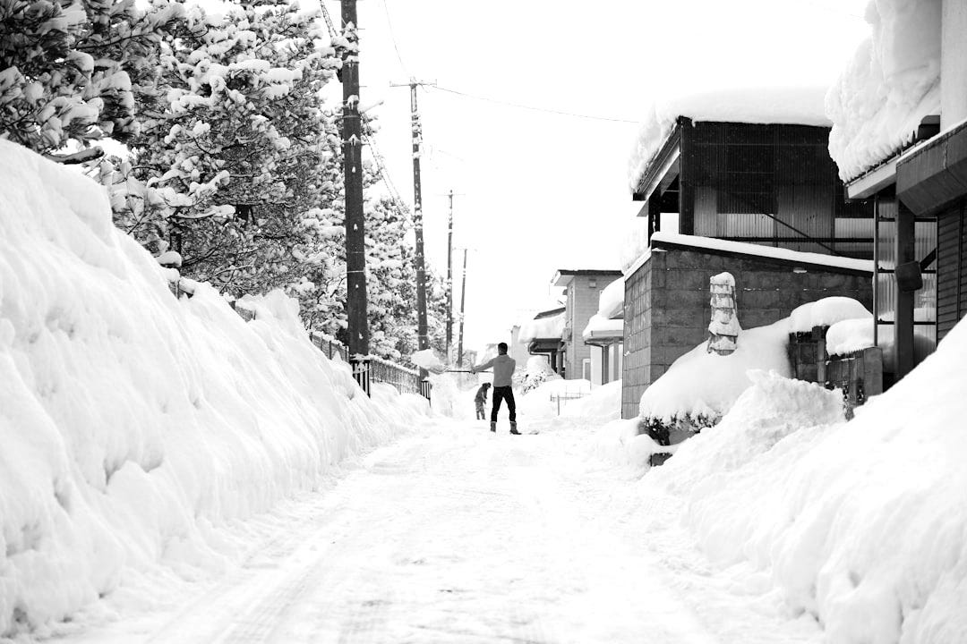a person walking down a snow covered street a person walking down a snow covered street