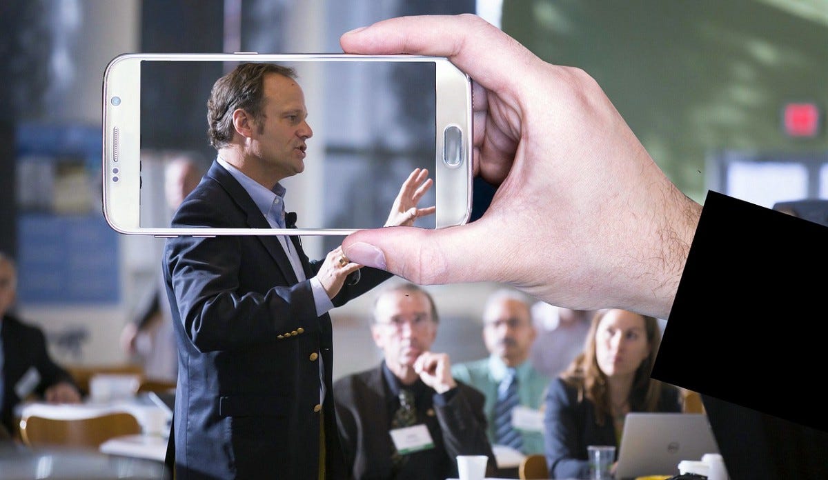 A man speaking in public confidently and demonstrating how to build self-confidence.
