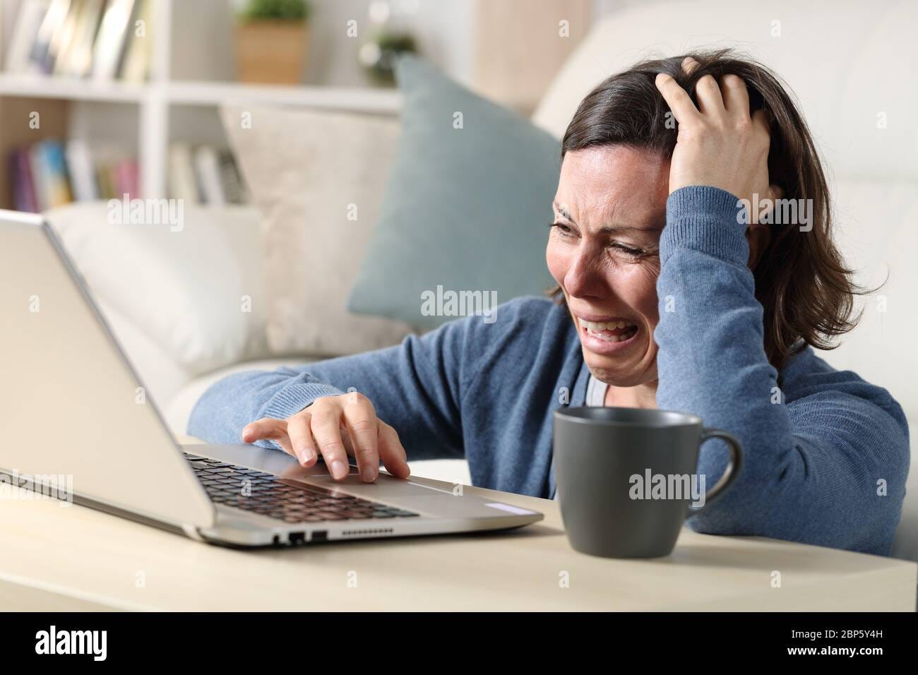 Crying while watching laptop hi-res stock photography and images - Alamy