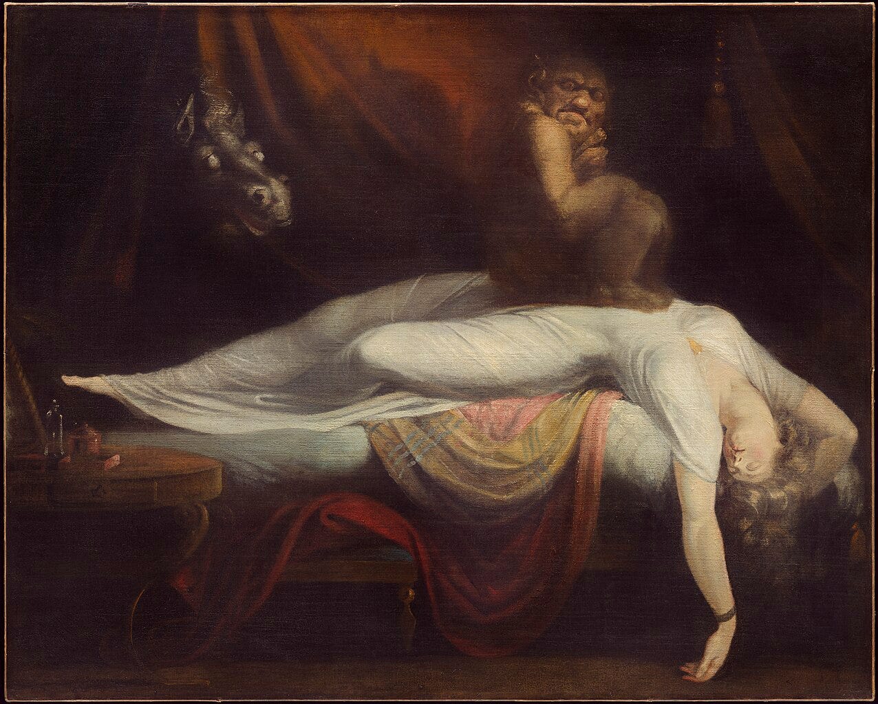 An oil painting of a woman in a white dress. She lies unconscious across a bed, her arm hanging down, while a dark, grotesque creature sits on her chest. In the shadows behind them, the head of a wide-eyed horse emerges. _The Nightmare_ (1781) by Henry Fuseli via [Wikimedia](https://en.m.wikipedia.org/wiki/The_Nightmare#/media/File%253AJohann_Heinrich_F%C3%BCssli_-_The_Nightmare_55.5.A-d1-2019-04-15.jpg)