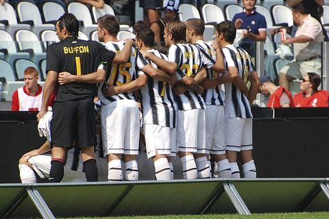 Juventus vs Parma, September 11, 2011: team huddle, player introductions, Antonio Conte coaching from the sideline, Pirlo and Del Piero in action, and Juventus players celebrating a goal during the opening match at Juventus Stadium.