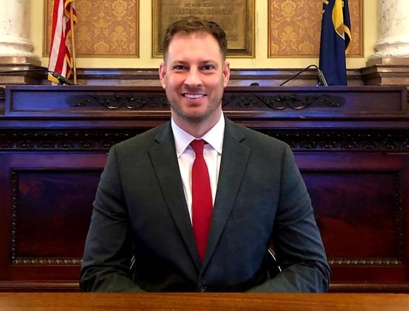 man in suit and red tie in capitol building