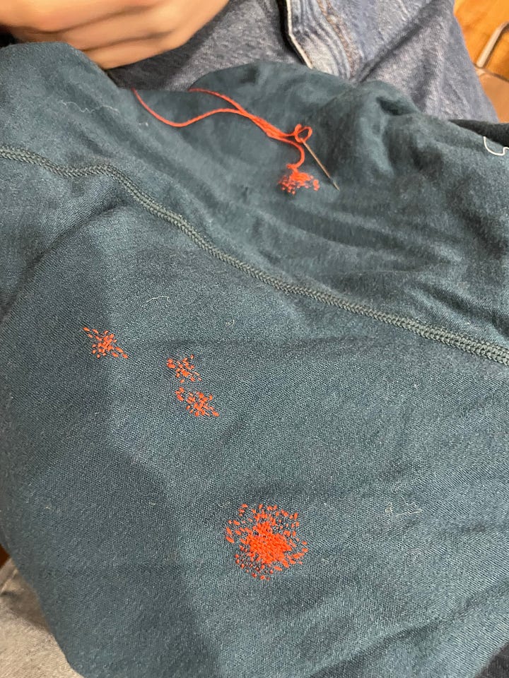 Two photos of darning on sweaters
