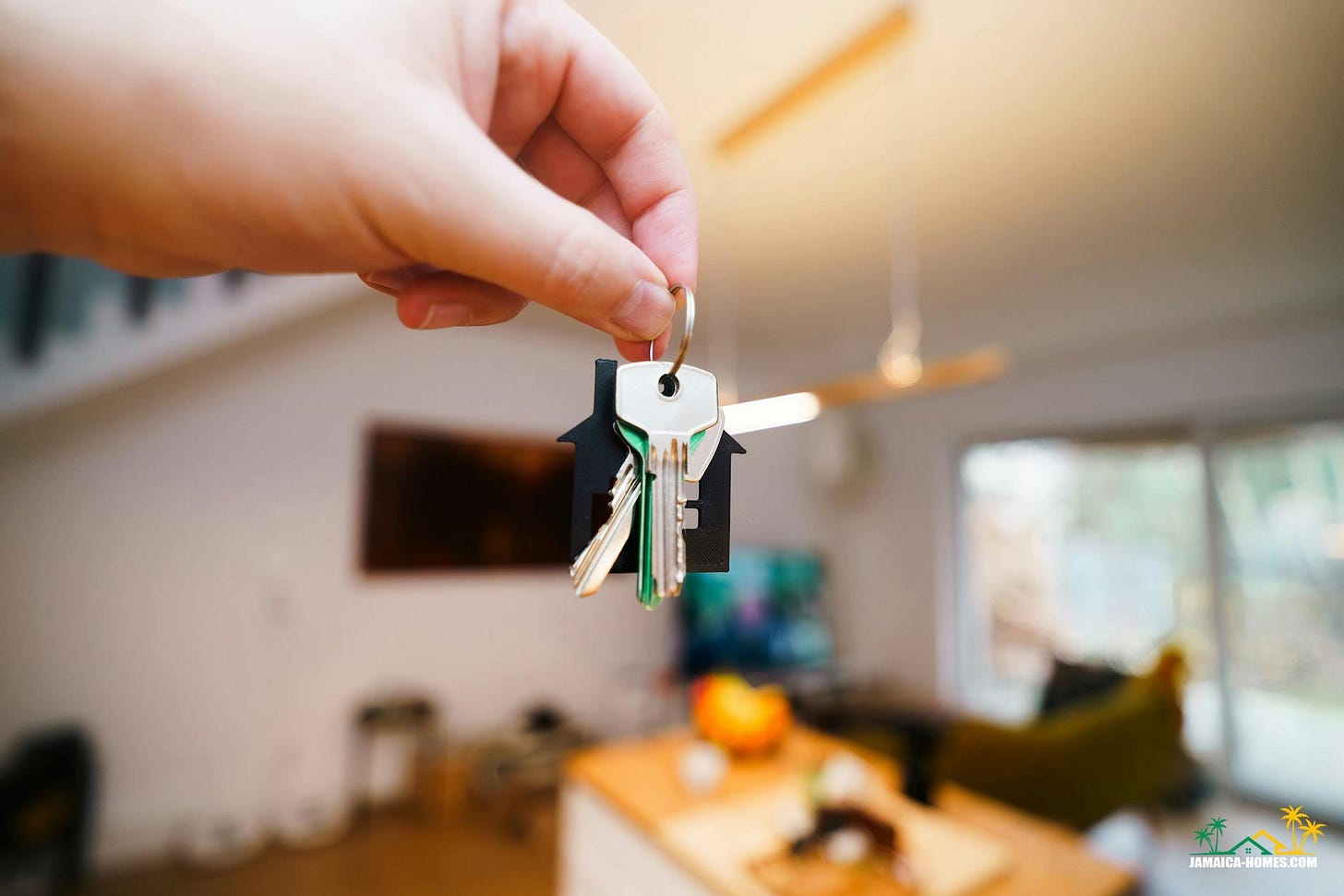 hand holding keys in modern home interior