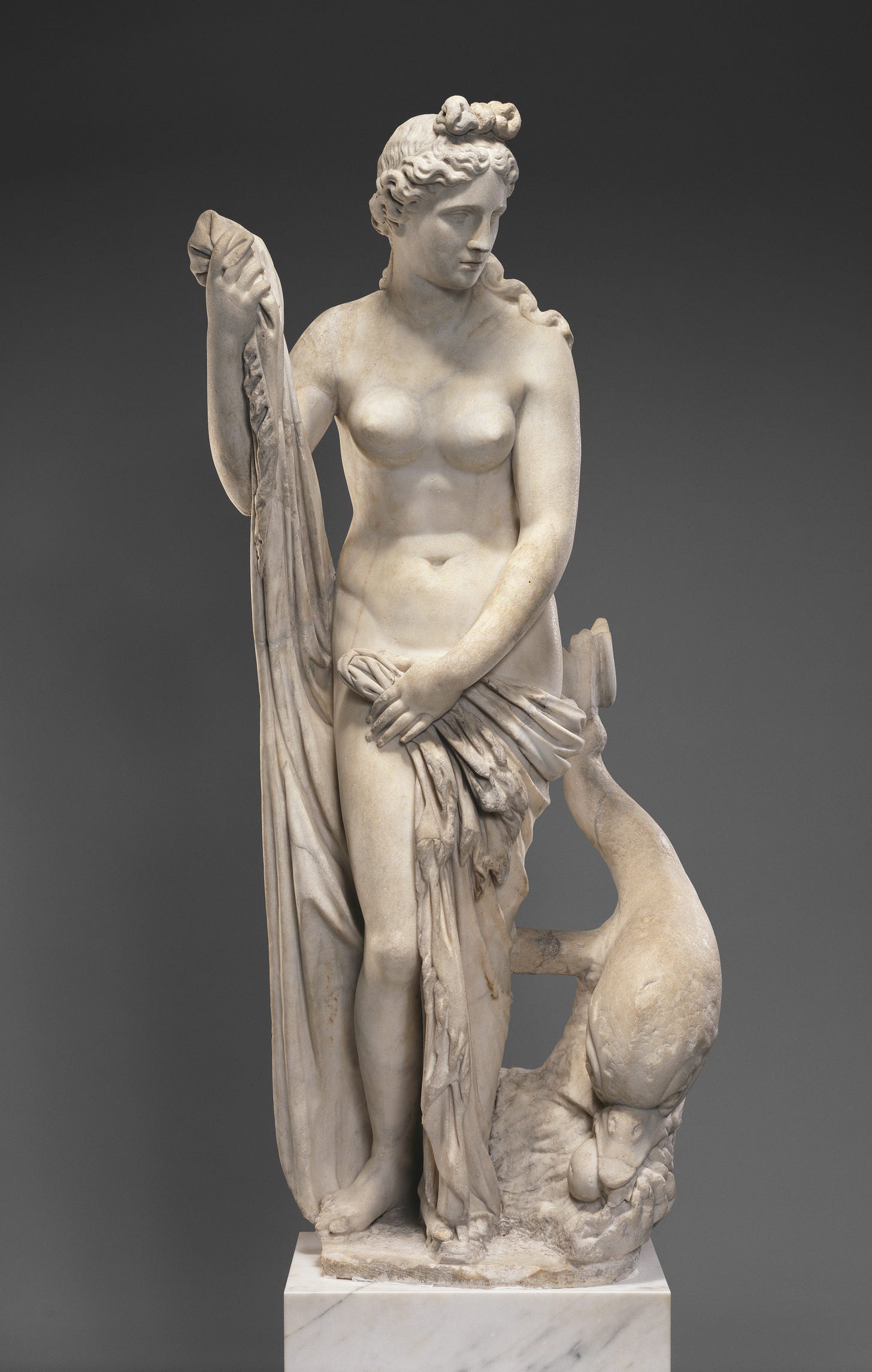 A red haired Venus surrounded by roses and honeysuckle holds an apple and an arrow A red haired Venus surrounded by roses and honeysuckle holds an apple and an arrow